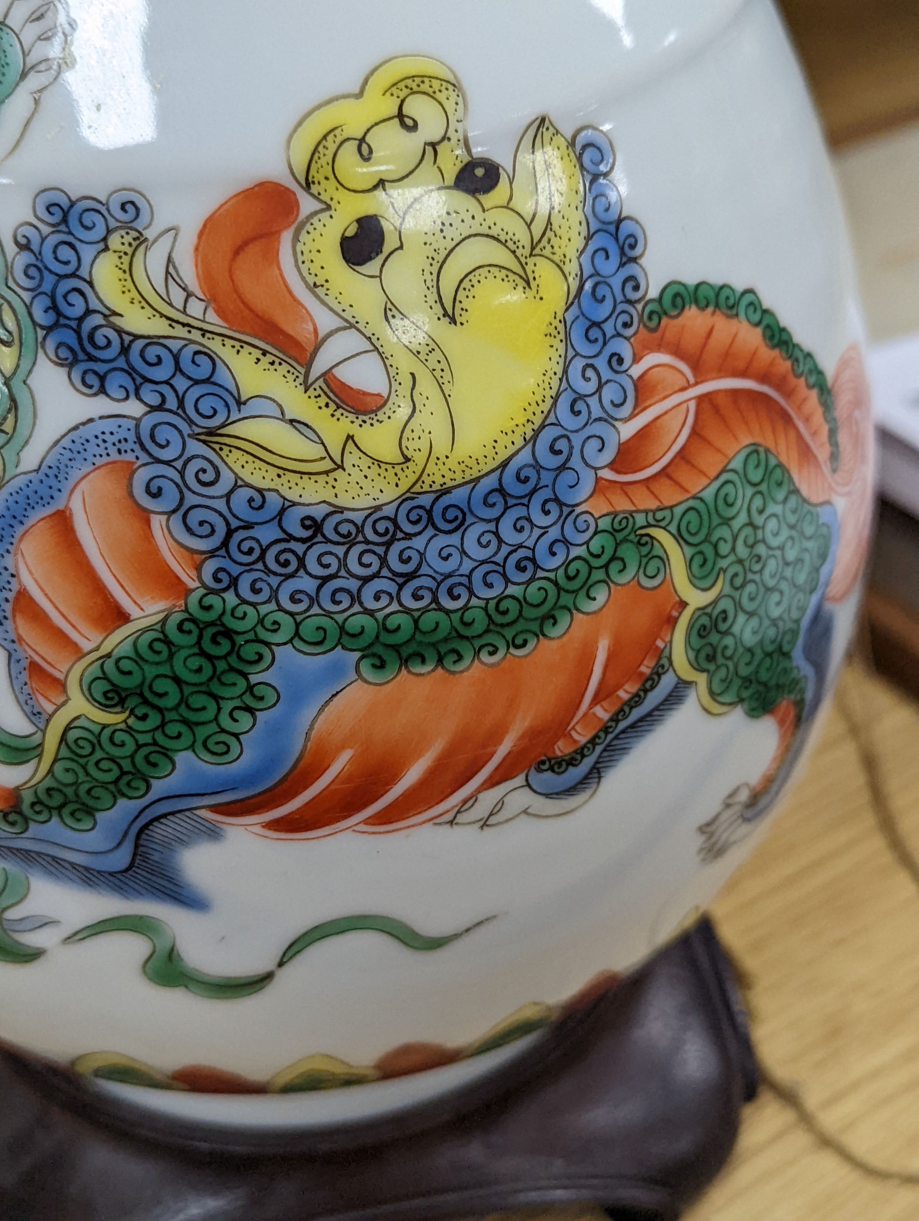 A Chinese famille verte pear shaped ‘Buddhist lion’ vase, on stand, 32 cms high not including stand.